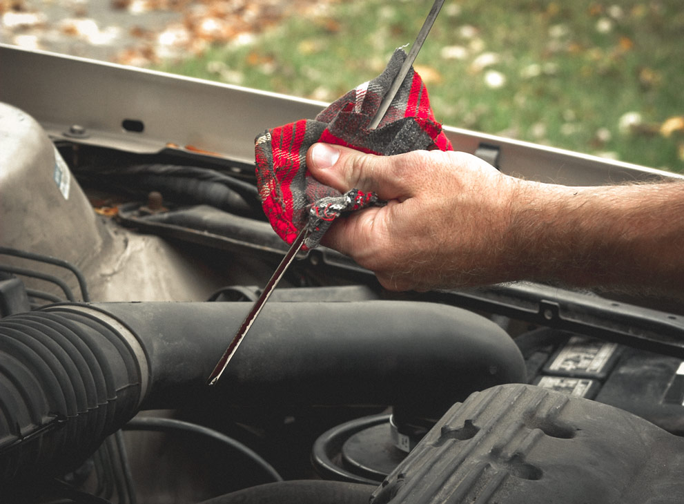 Man checking the engine oil