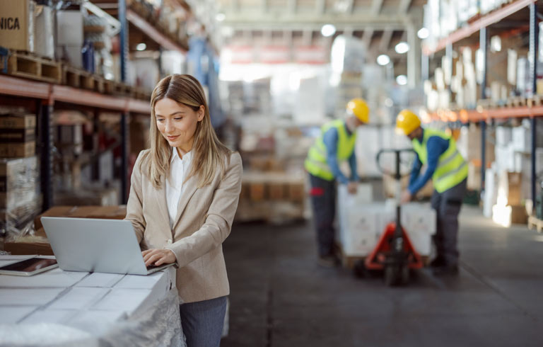 Businesswoman working in a warehouse.