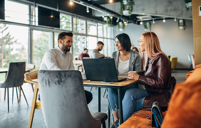 three coworkers having a business meeting at a restaurant