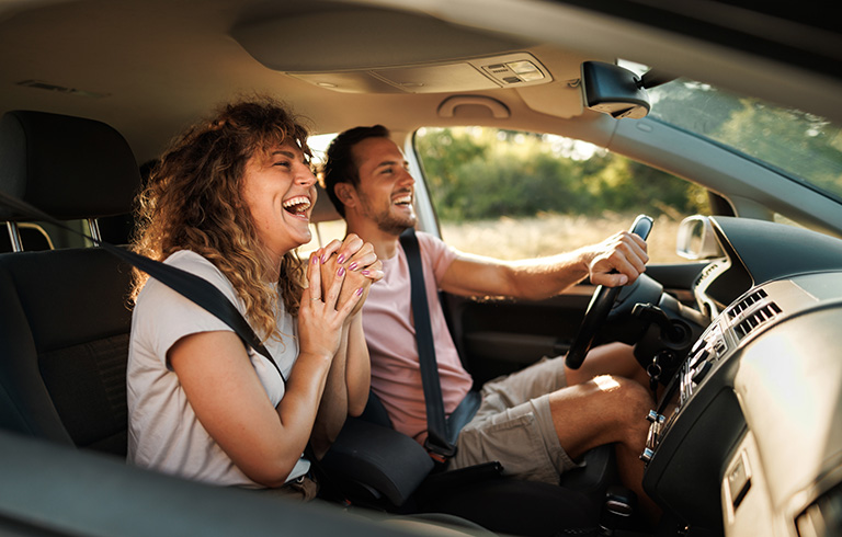 happy couple driving