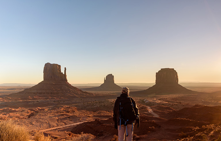 man hiking in red rock scenery