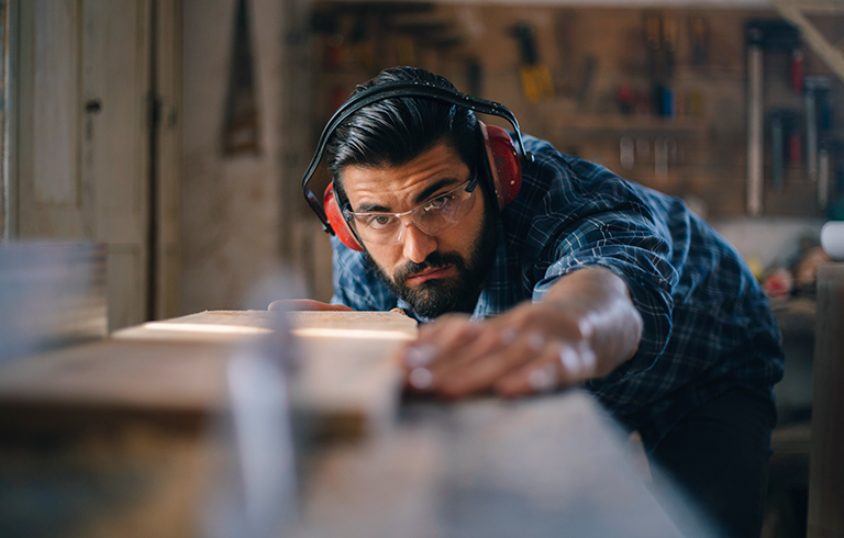 man using a saw