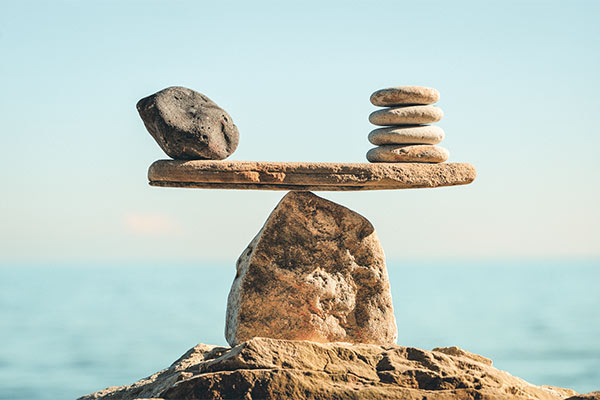 Rocks teetering on top of another rock