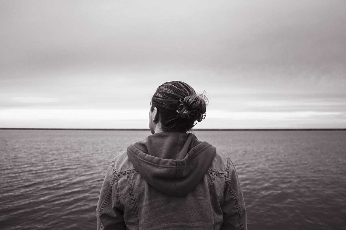 man looking at ocean horizon
