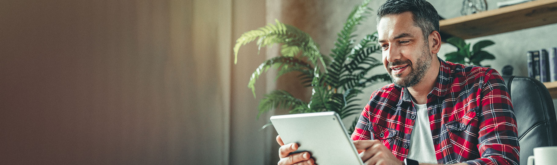 man working on his tablet