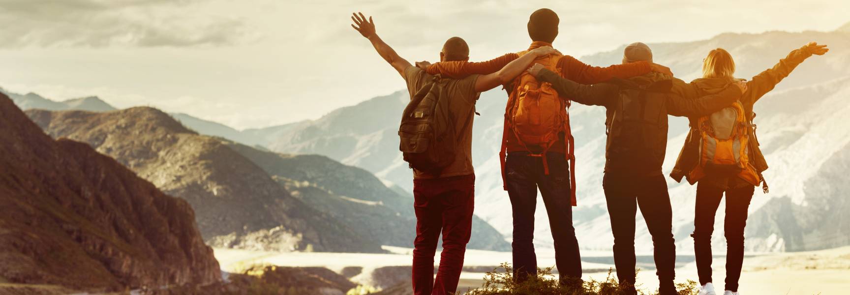 friends hugging on an adventure in the mountains