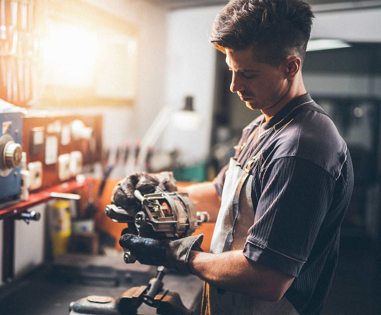 man fixing car parts