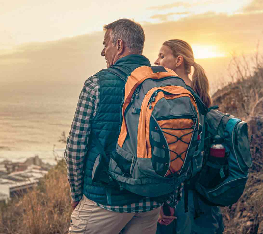 Couple hiking on a seaside mountain