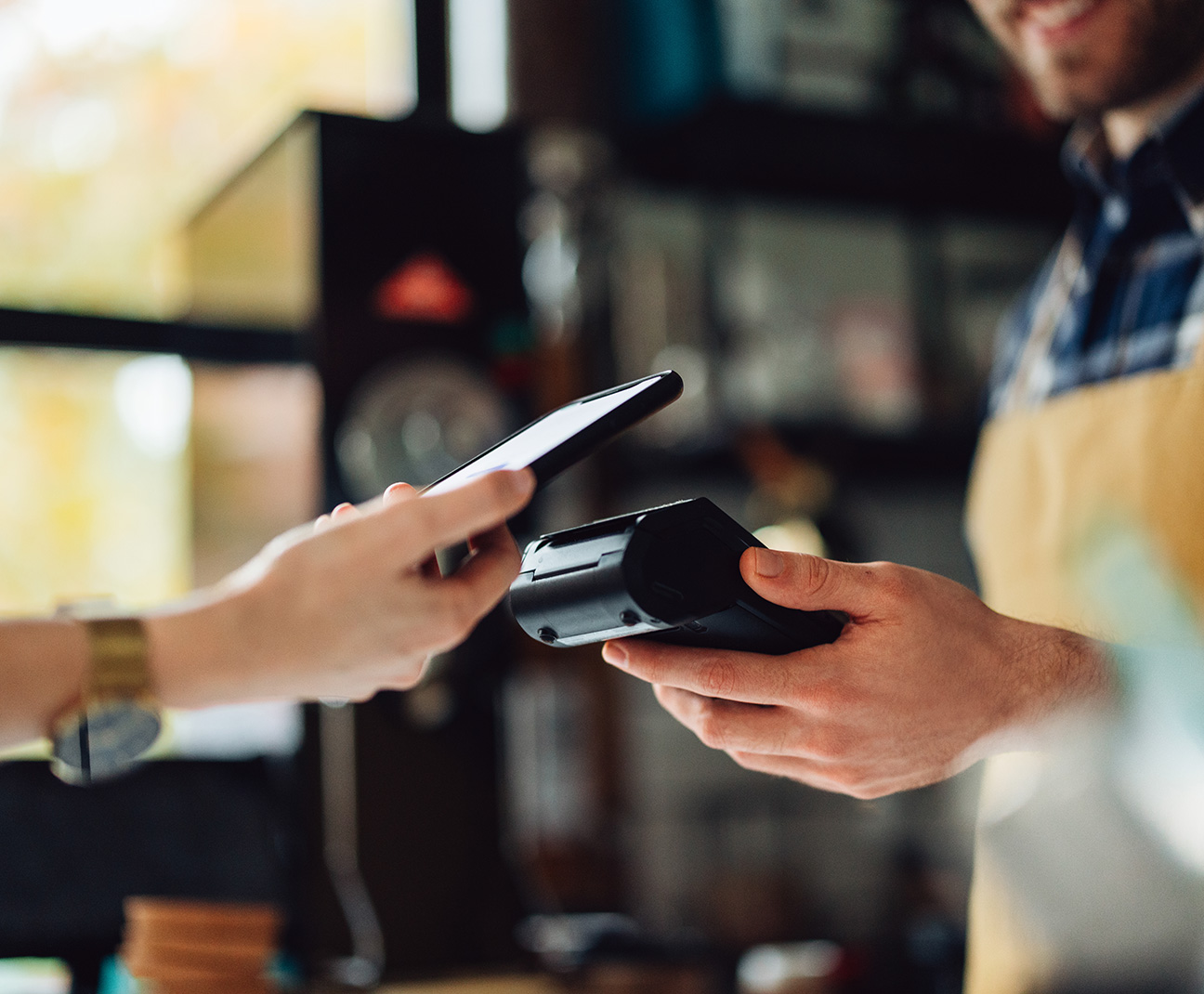 person paying with tap-to-pay at the register