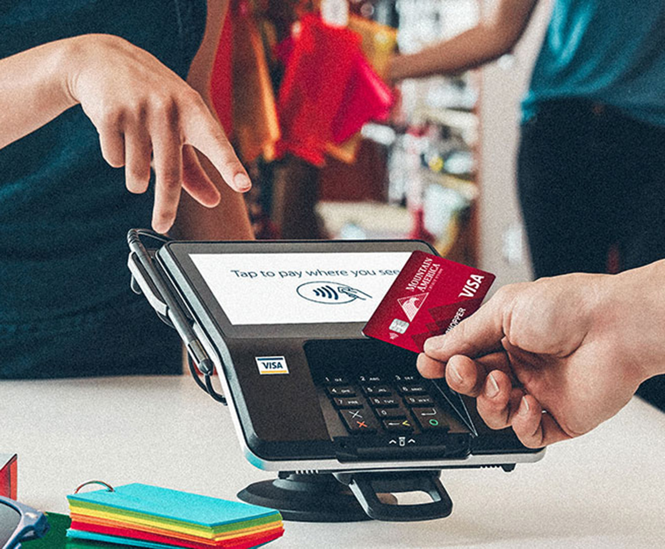 person using tap-to-pay with their Mountain America card