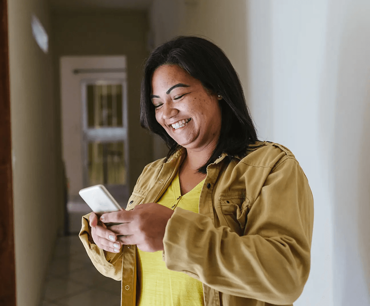 Woman using Zelle on a phone