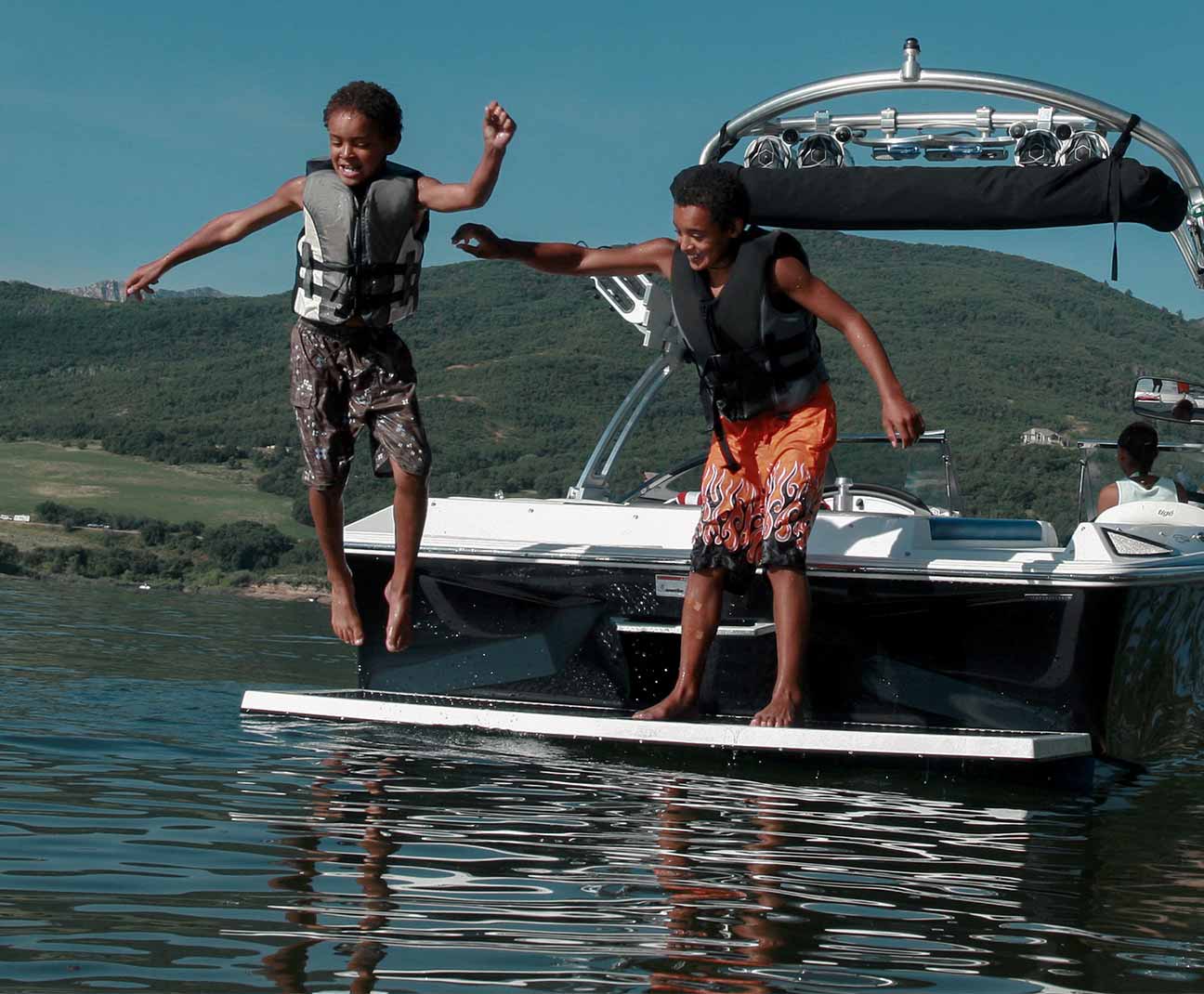 kids diving off of a boat