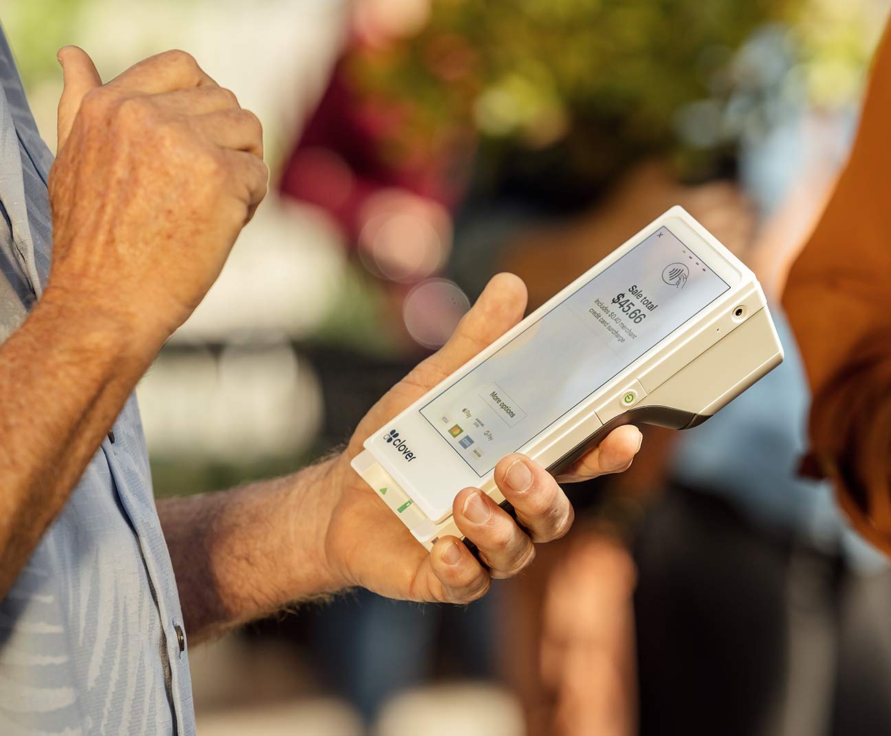 man holding credit card reader