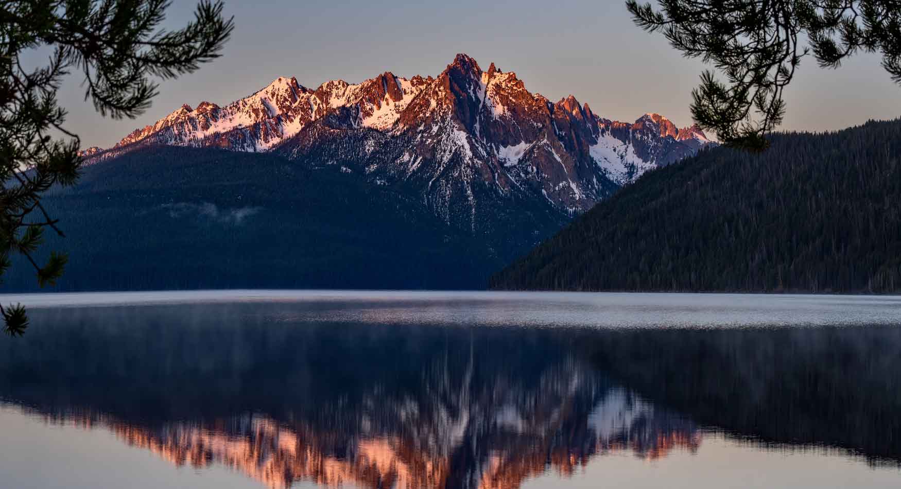 Scenic view of mountains reflecting on a lake.