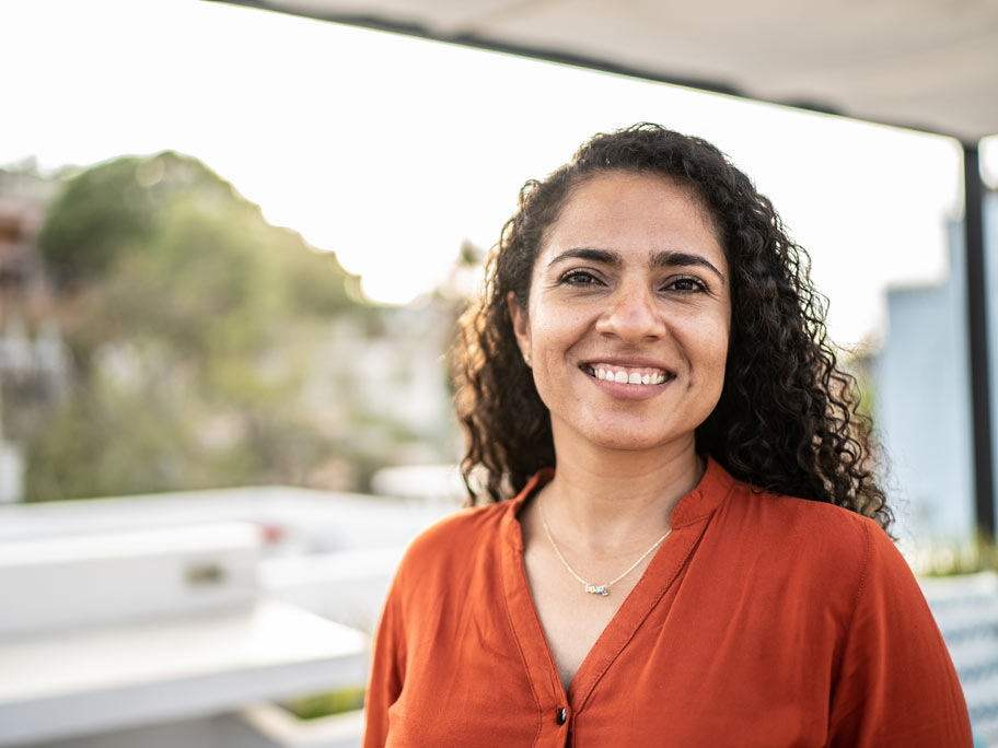 Portrait of smiling woman outdoors.