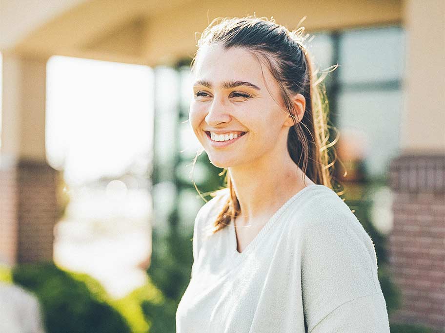 Happy woman in front of bank