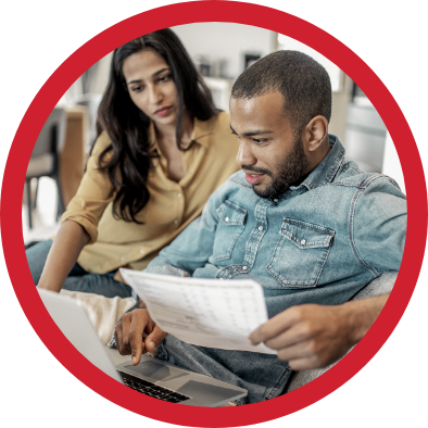 A young couple reviewing paperwork.