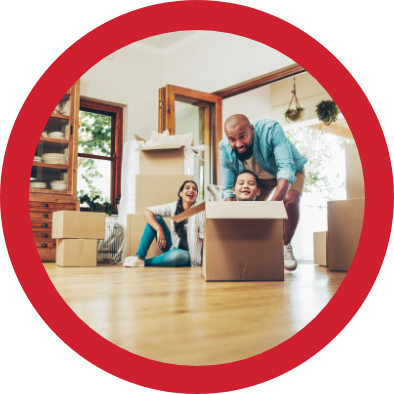 A young family unpacks boxes in their new home.