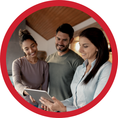 Realtor and young couple looking at tablet.