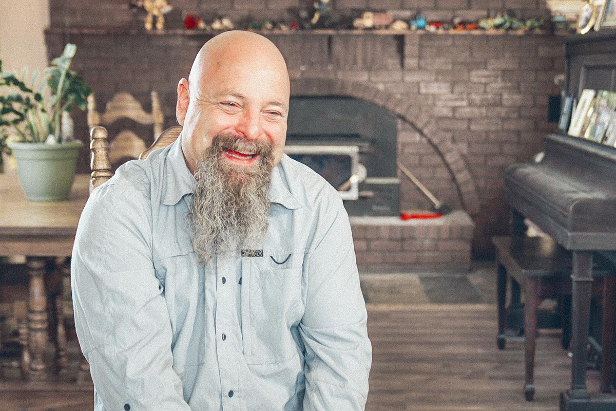 Terence White smiling in his home