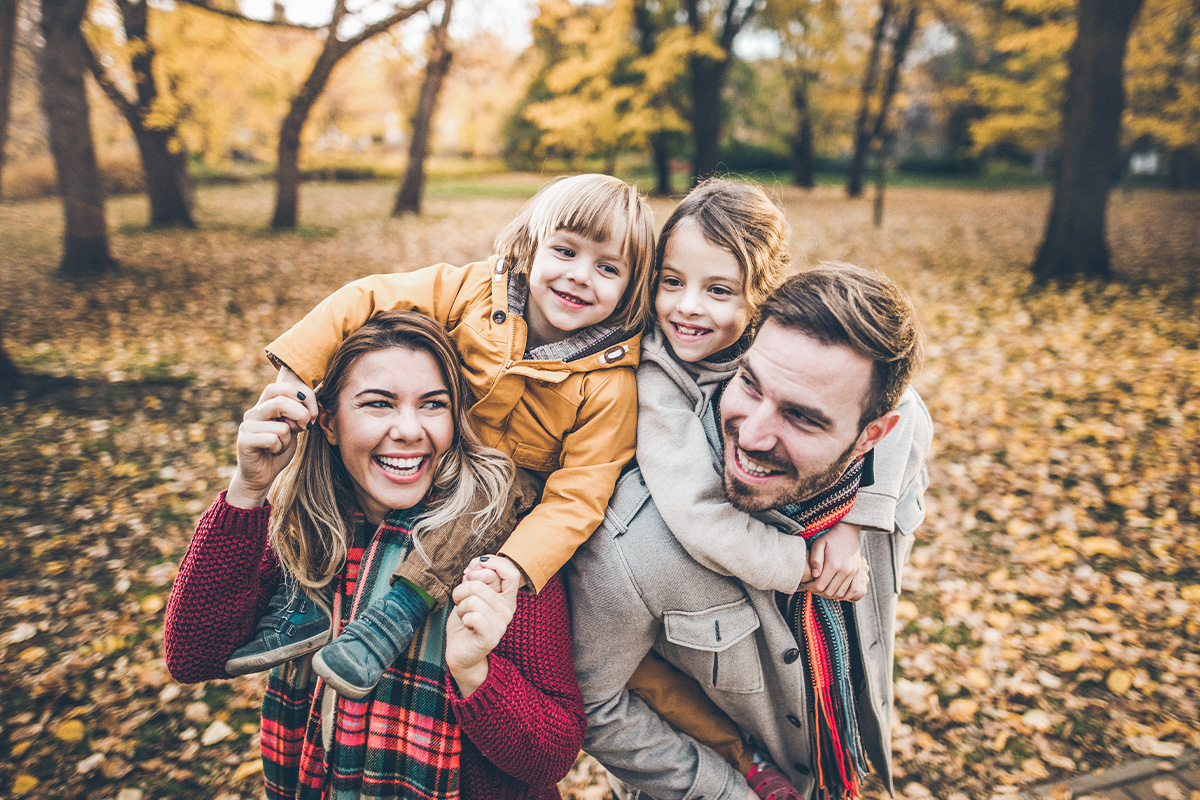 Family together with a fall backdrop