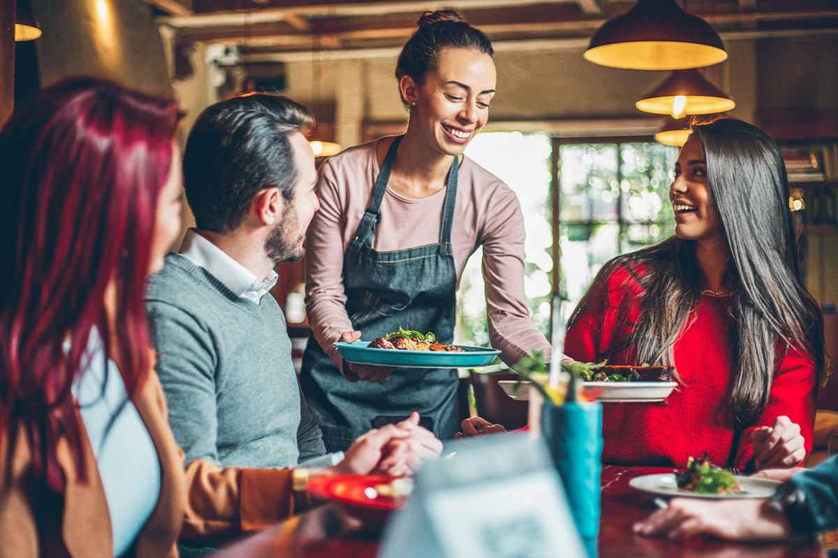 Women serving food to people in a restaurant