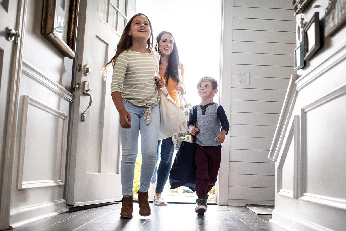 Family walking through front door of home