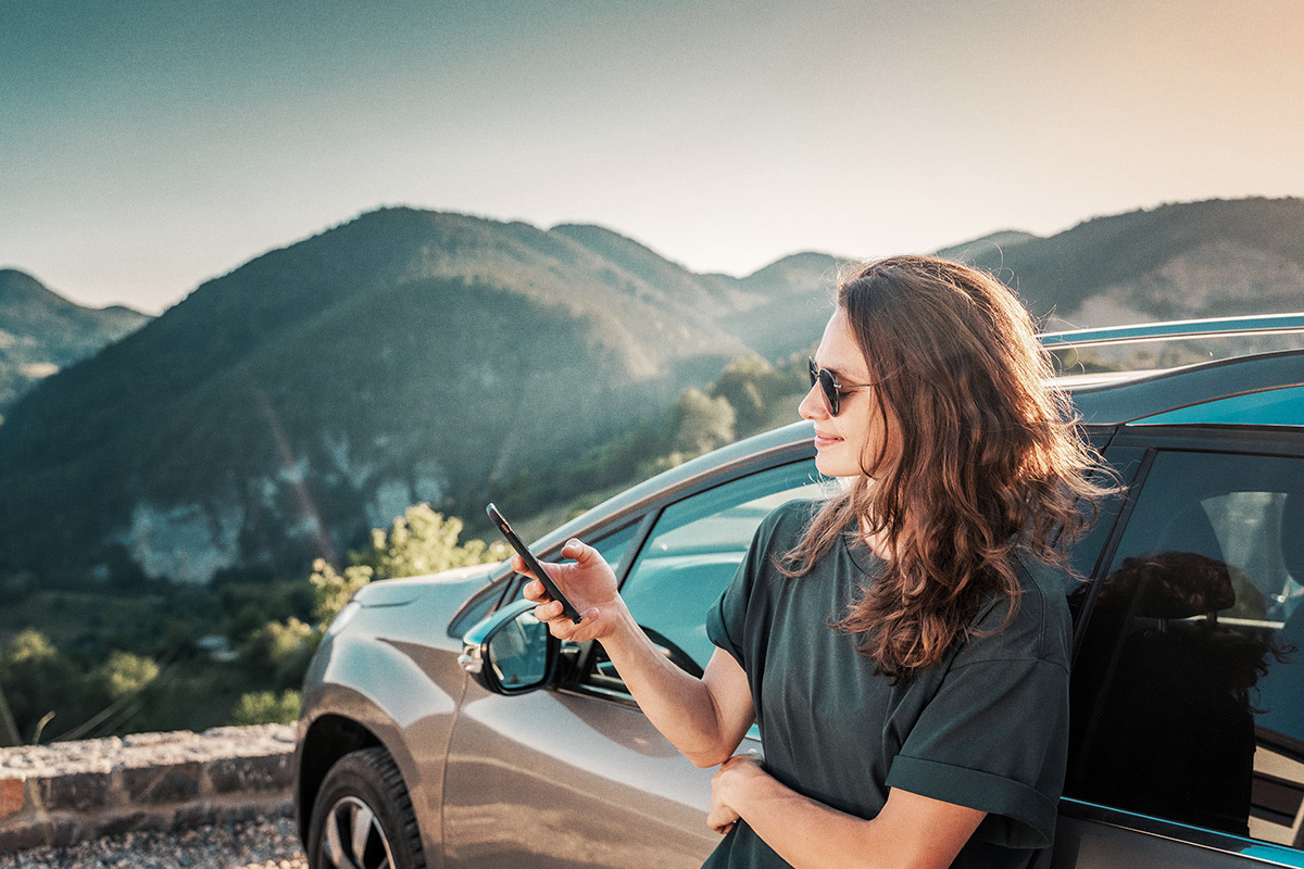 woman on road trip checking bank balance