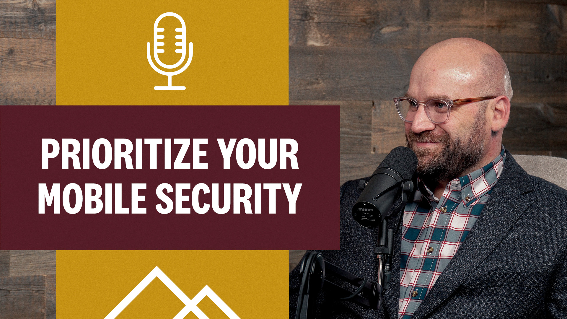 man in glasses and plaid shirt at podcast mic