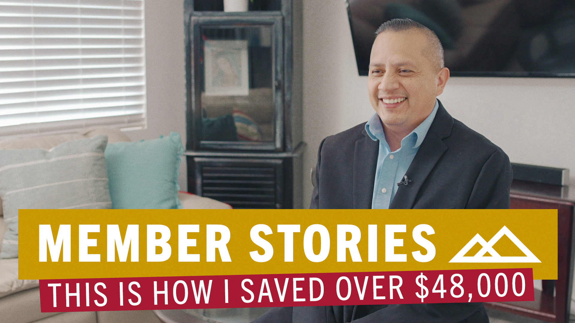 Hispanic man sitting in living room smiling