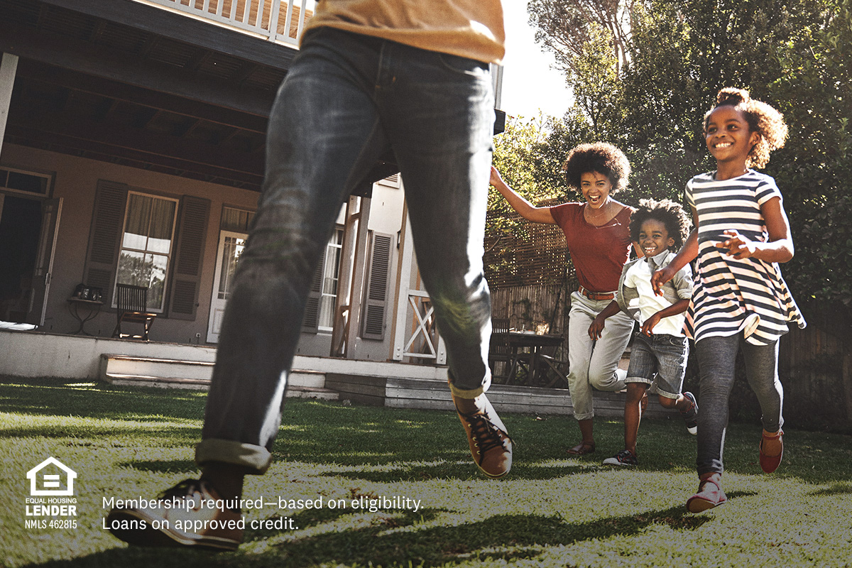 family running in back yard of home