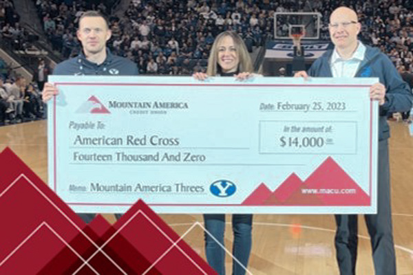 people holding 14,000 dollar check from Mountain America donated to The Red Cross