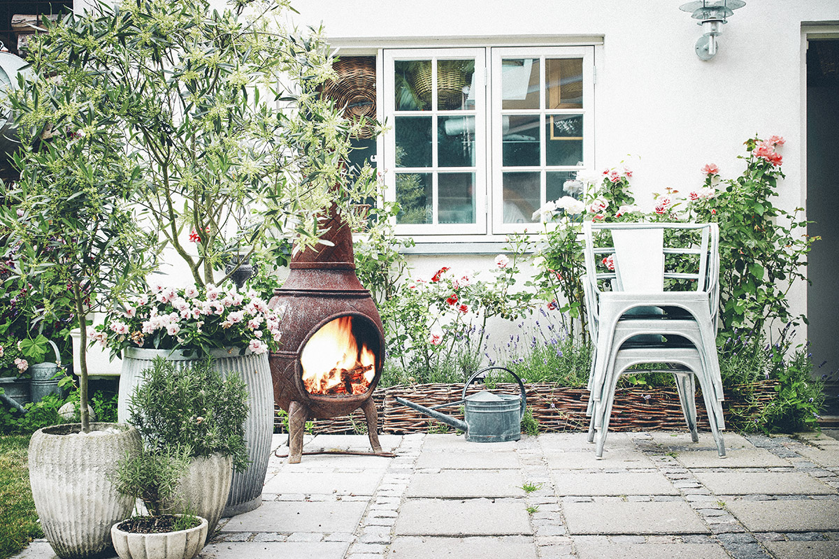 patio with plants and a small furnace