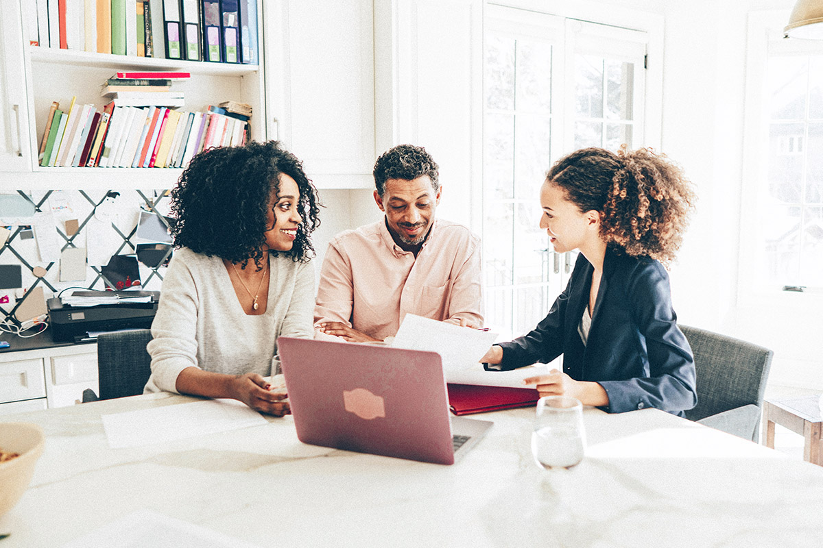 couple looking at mortage paperwork with a realtor