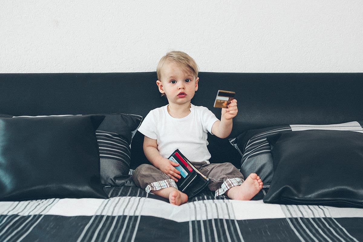baby holding a wallet and credit card
