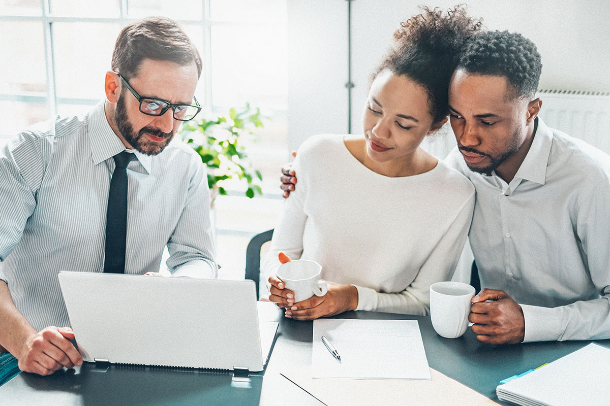 financial advisor helping a couple stay financially educated