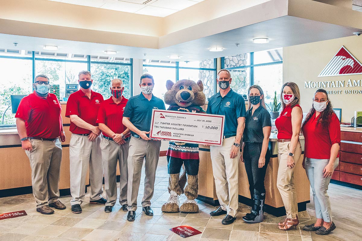 Mountain America employees holding check for Fighter Country Foundation