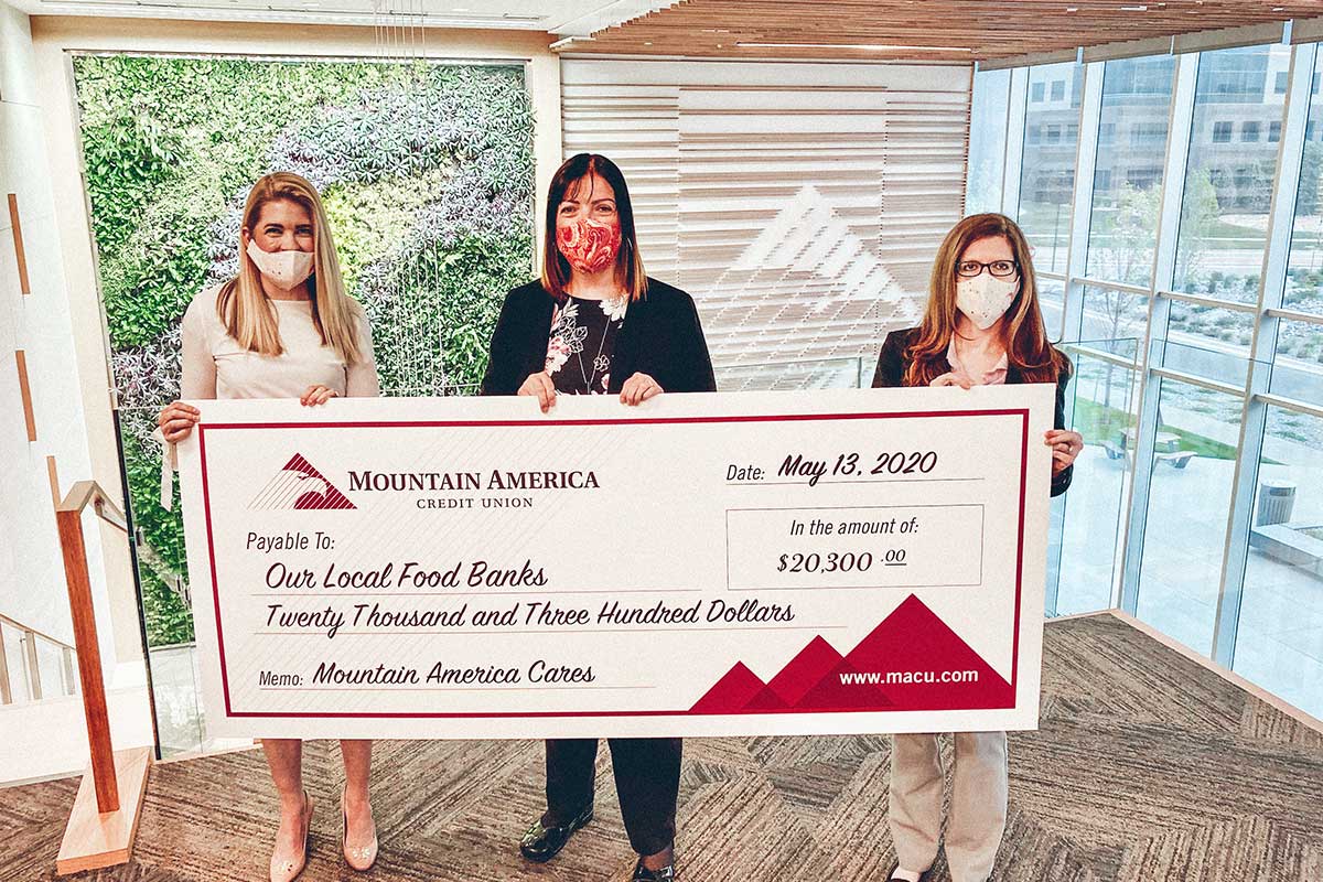 Mountain America employees holding a check for local food banks