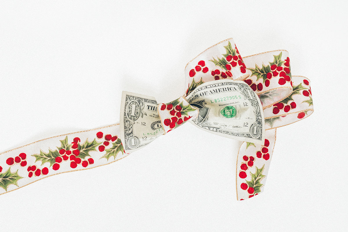 dollar bill tied up in a Christmas bow