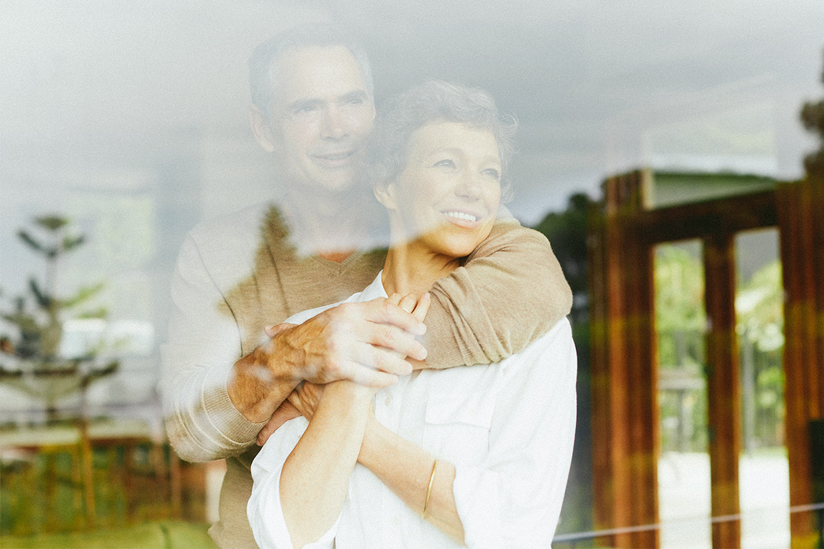 couple hugging and looking out a window