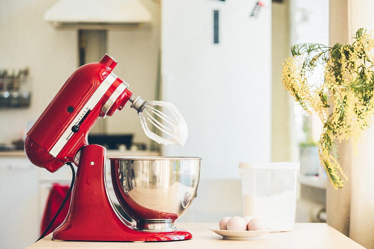 red kitchen mixer on the counter