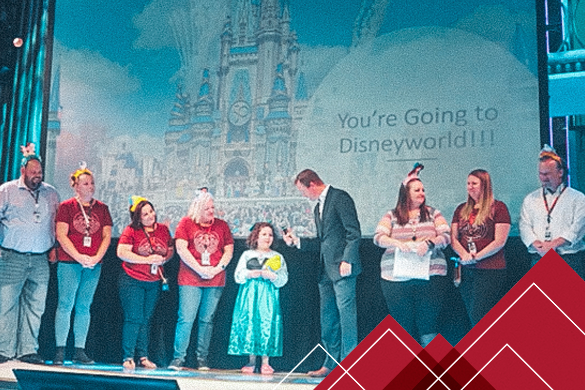 Illeana on stage receiving a trip to Disney World