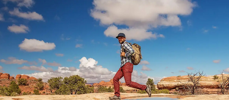 Man hopping over a stream