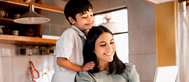 mother and son looking at tablet in the kitchen