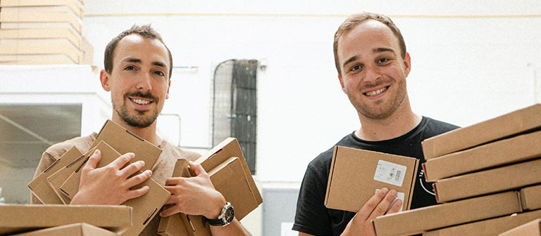 two men holding boxes