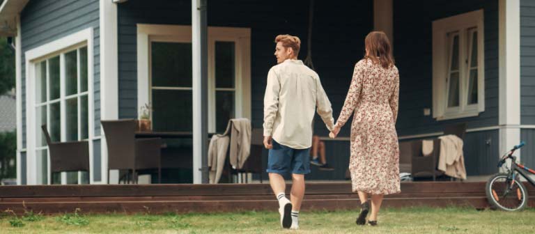 Couple in front of their home