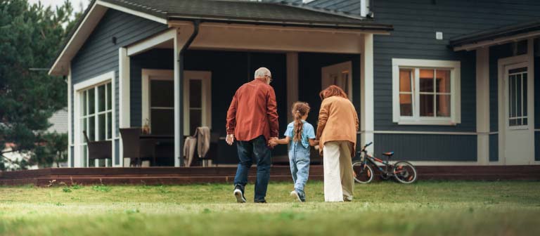 family in front of house