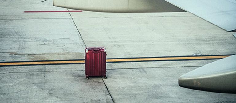 lonely luggage outside of a plane
