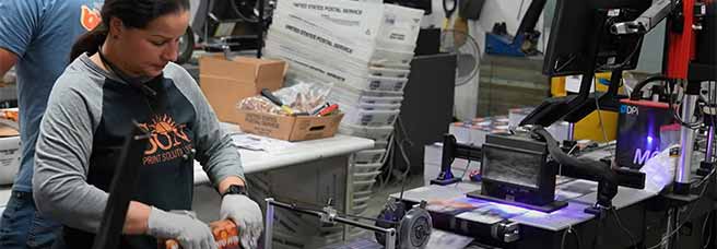 Woman operating printing press